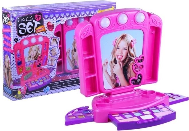 Pink kids’ vanity with makeup and lights
