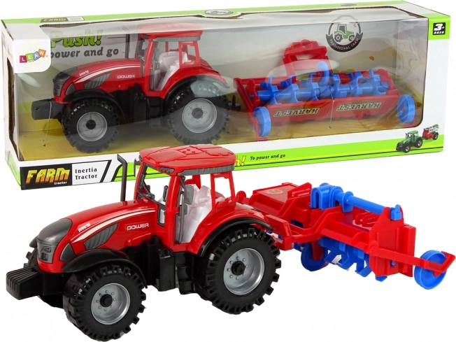Punane hõõrdejõuga traktor adraga