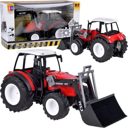 Suur punane traktor liikuva laadurihoova ja suurte ratastega