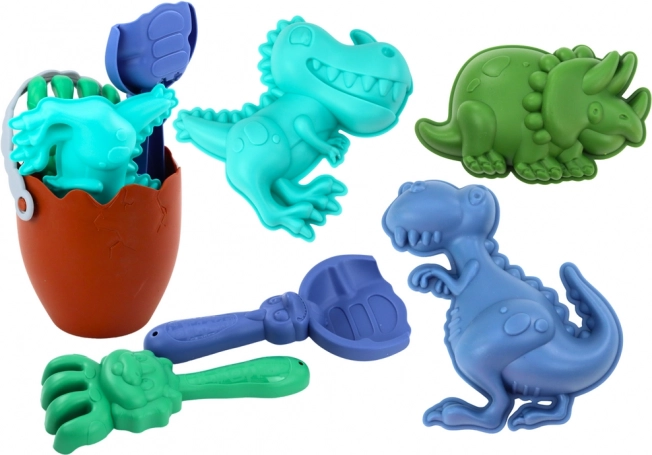 Liivakomplekt dinosaurustega: munakujuline ämber, labidas, reha ja vormid